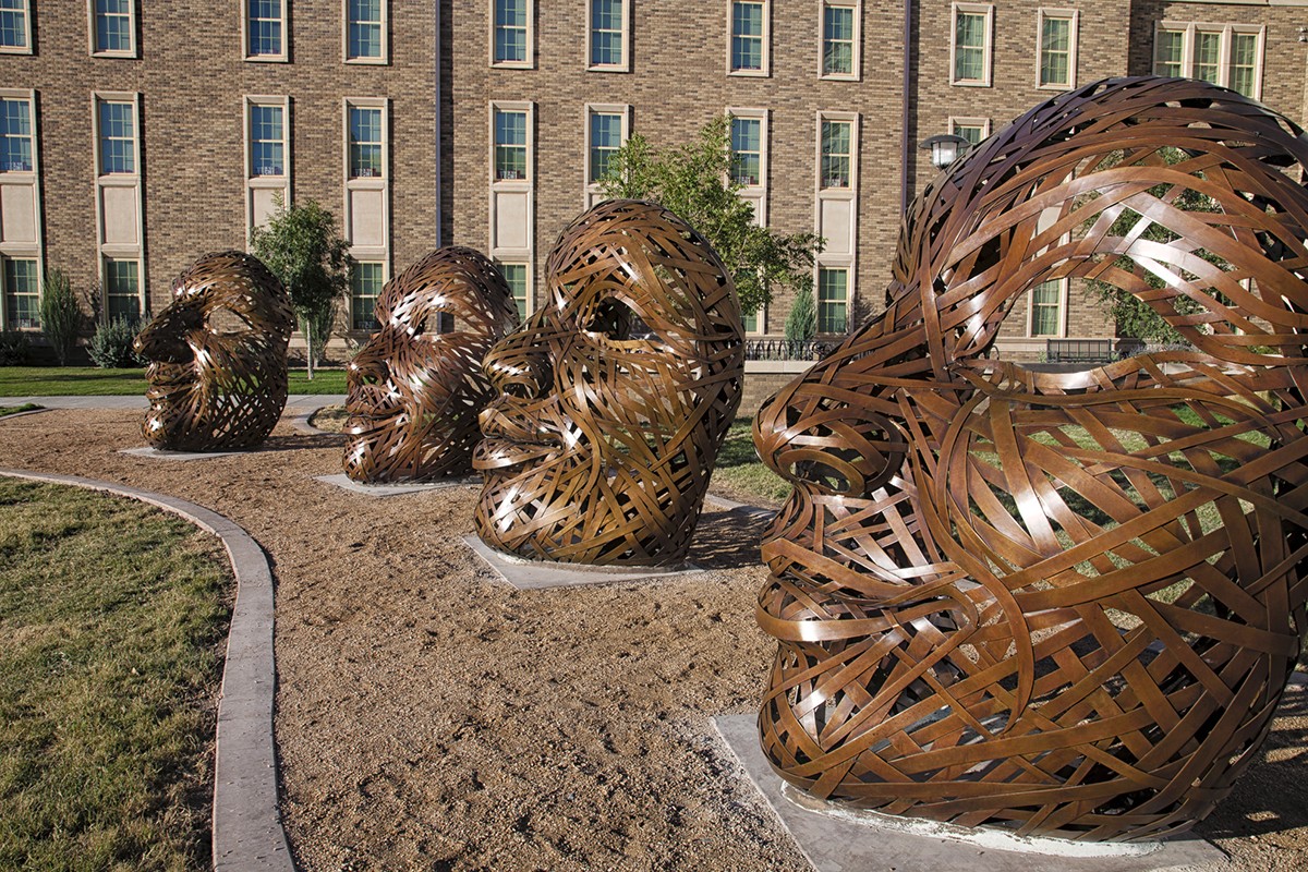 image of 4 faces bronze sculptures